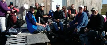 a group of people sitting outside of a building