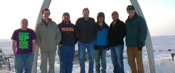 a group of people standing next to each other in the snow