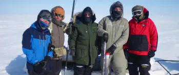 a group of people standing next to each other in the snow