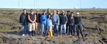 a group of people standing on a rocky outcropping